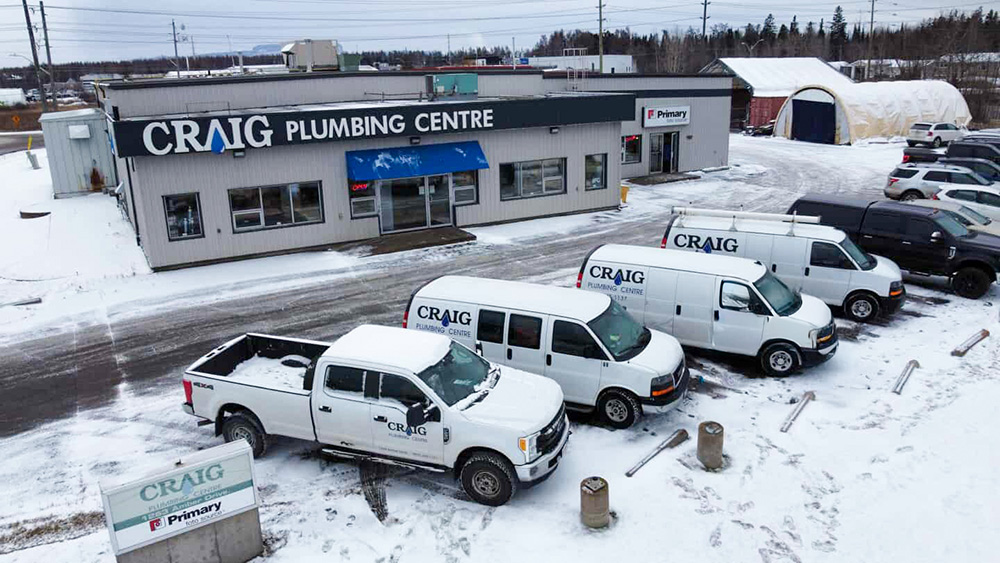 aerial view of Craig Plumbing Centre front of store with branded, white fleet of vehicles